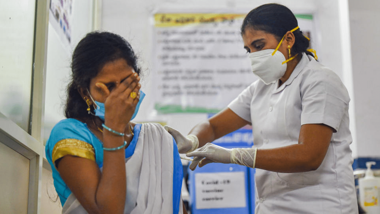 A medic administers the first dose of Covishield vaccine to a frontline worker, after the virtual launch of Covid-19 vaccination drive by Prime Minister Narendra Modi, at a health center in Visakhapatnam, Saturday, Jan. 16, 2021. Credit: PTI Photo