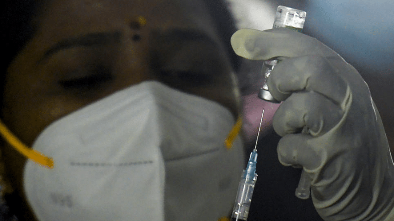 A medical worker prepares to inoculate a colleague with a Covid-19 coronavirus vaccine at the government Rajaji hospital in Madurai on January 16, 2021. Credit: AFP Photo