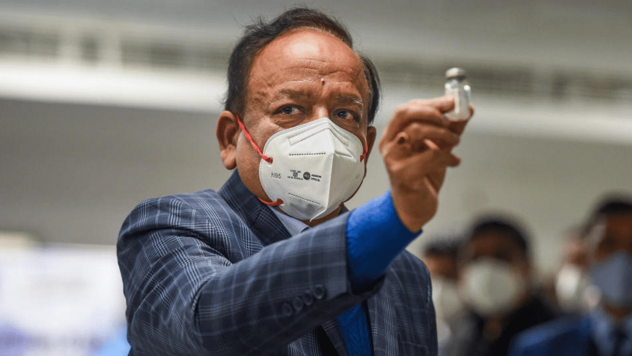 Union Health Minister Harsh Vardhan displays a Covishield vaccine vial, after the virtual launch of COVID-19 vaccination drive by Prime Minister Narendra Modi, at AIIMS in New Delhi, Saturday, Jan. 16, 2021. Credit: PTI Photo