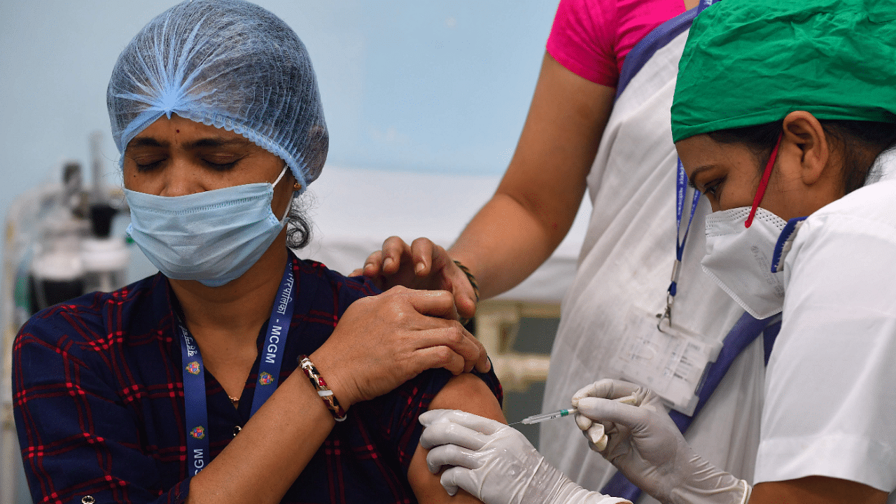 A medical worker inoculates a colleague with a Covid-19 coronavirus vaccine at the Rajawadi Hospital in Mumbai. Credit: AFP Photo