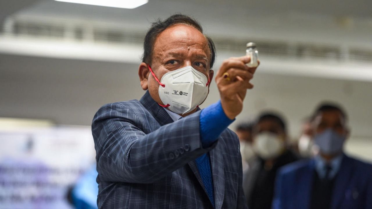 Union Health Minister Harsh Vardhan displays a Covishield vaccine vial, after the virtual launch of Covid-19 vaccination drive by Prime Minister Narendra Modi, at AIIMS in New Delhi. Credit: PTI Photo