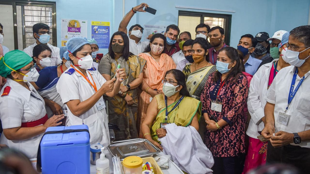 Medics and health workers applause for Dr Vidya Thakur after she took the first dose of the Covishield vaccine, following the virtual launch of COVID-19 vaccination drive by Prime Minister Narendra Modi, at Rajawadi hospital in Mumbai. Credit: PTI.