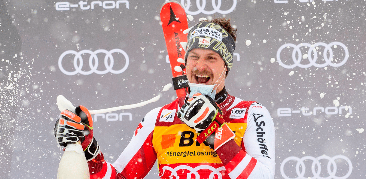 Austria's Manuel Feller celebrates his victory on the podium after the second run of the slalom event. Credit: AFP Photo