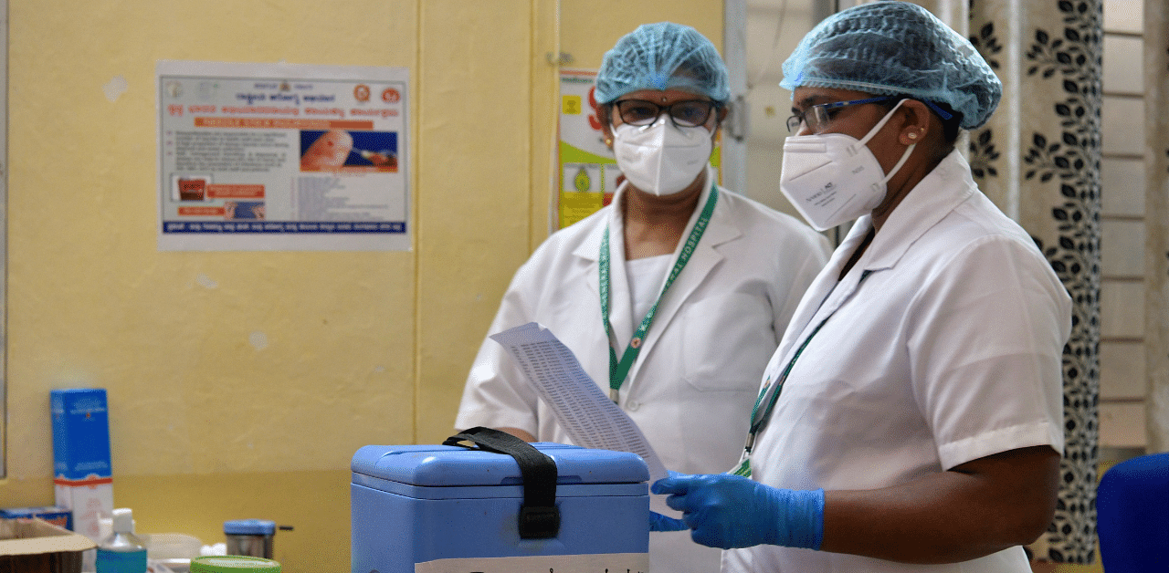 Nurses prepare to administer a Covid-19 coronavirus vaccine to health workers. Credit: AFP Photo