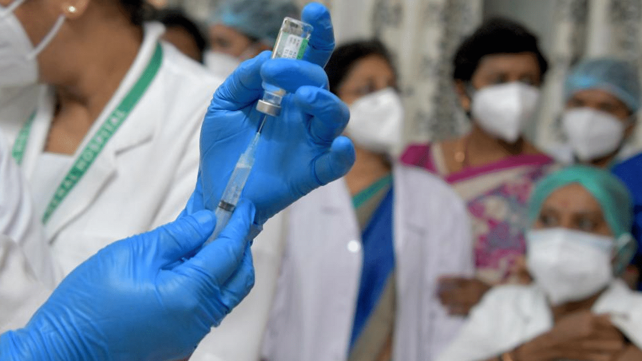  A nurse prepares to administer a Covid-19 coronavirus vaccine to health workers at the KC General hospital in Bangalore on January 16, 2021. Credit: AFP Photo