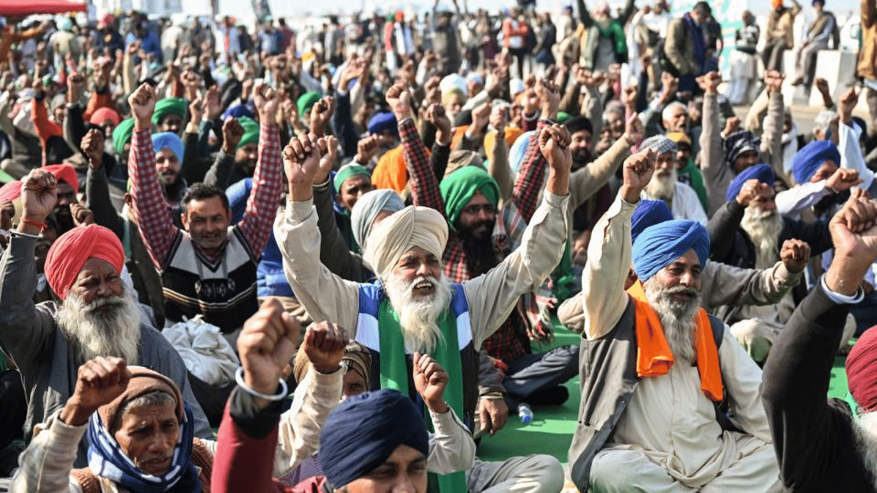 Protesting farmers shout slogans as they sit along a blocked highway during a protest against the central government's recent agricultural reforms at the Ghazipur Delhi-Uttar Pradesh state border in New Delhi on January 11, 2021. Credit: AFP Photo
