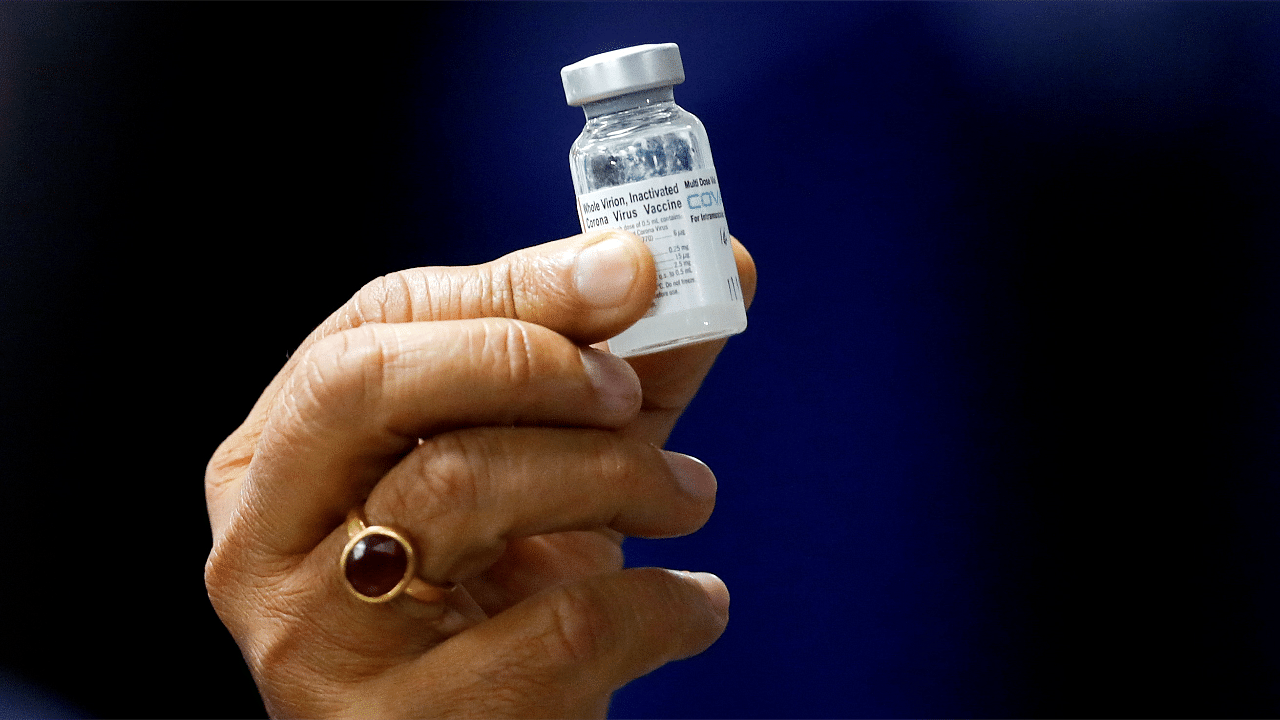 Health Minister Harsh Vardhan holds a dose of Bharat Biotech's Covid-19 vaccine called COVAXIN. Credit: Reuters Photo