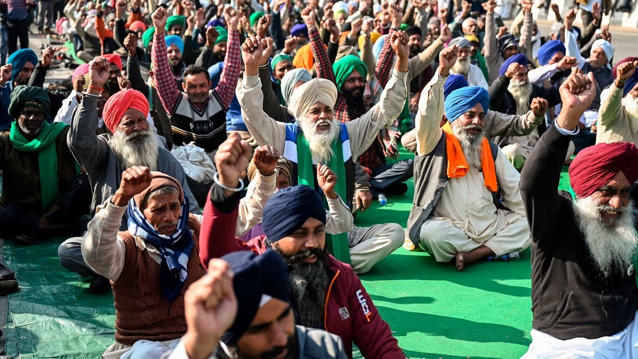 Protesting farmers shout slogans as they sit along a blocked highway during a protest against the central government's recent agricultural reforms at the Ghazipur Delhi-Uttar Pradesh state border in New Delhi. Credit: AFP Photo
