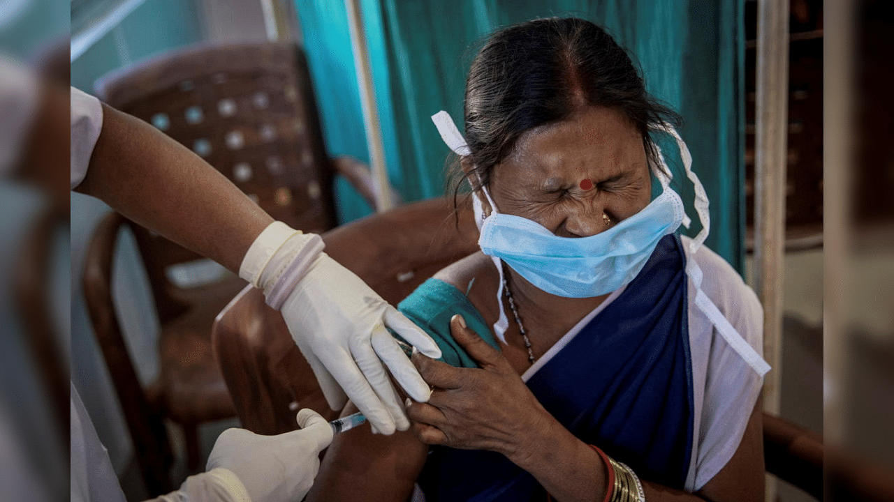 A healthcare worker reacts as she receives a dose of COVISHIELD, a COVID-19 vaccine manufactured by Serum Institute of India, during one of the world's largest COVID-19 vaccination campaigns at Mathalput Community Health Centre in Koraput district of the eastern state of Odisha, India, January 16, 2021. Credit: Reuters Photo