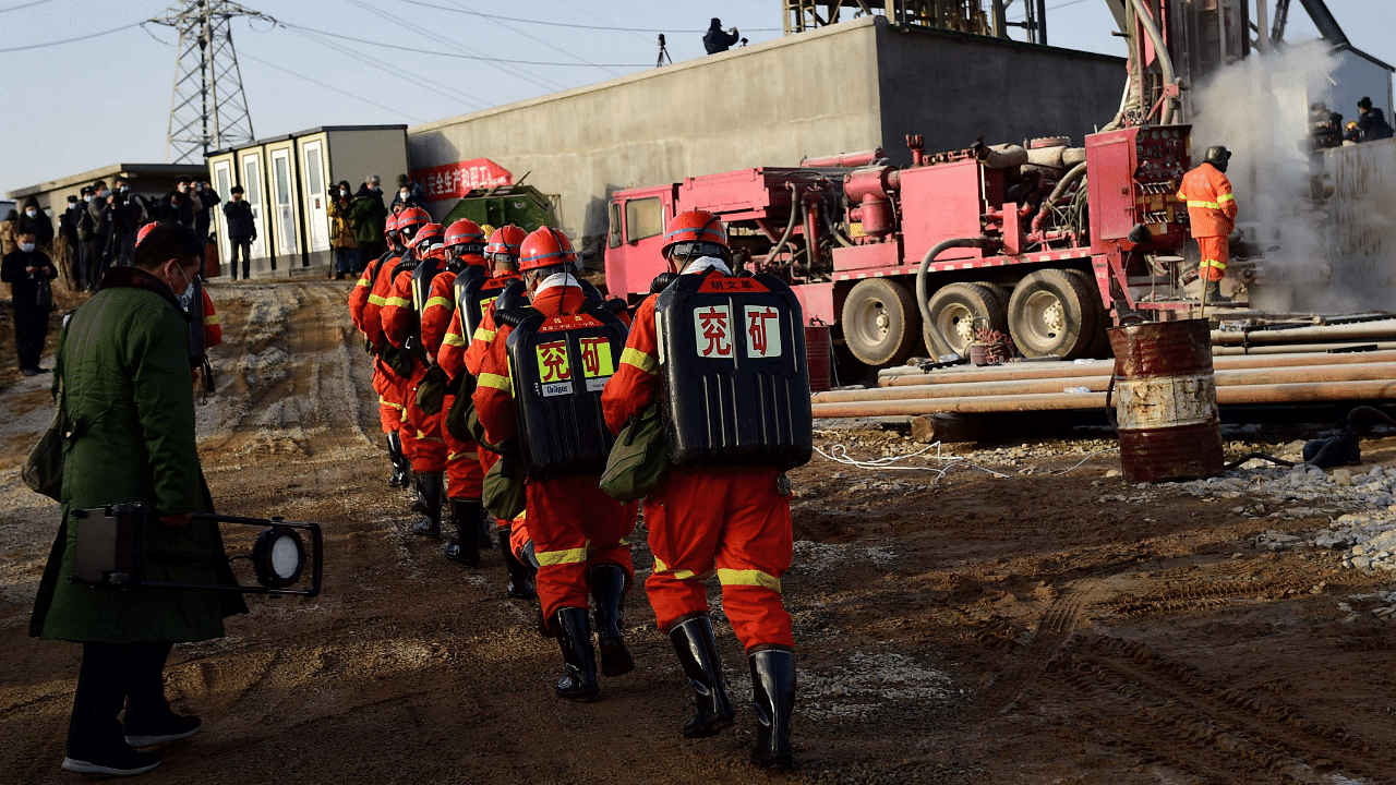 This photo taken on January 13, 2021 shows rescuers working at the site of gold mine explosion where 22 miners were trapped underground in Qixia, in eastern China's Shandong province. Credit: AFP File Photo