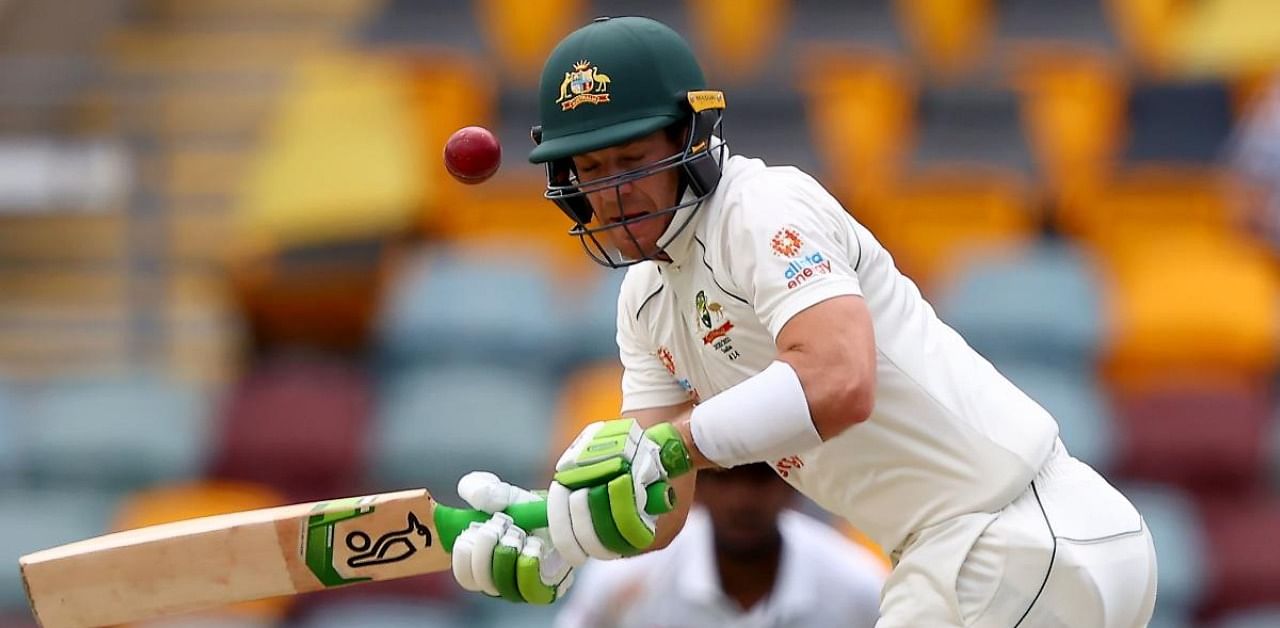 Australia's captain Tim Paine plays a shot on day four of the fourth cricket Test match between Australia and India at The Gabba in Brisbane on January 18, 2021. Credit: AFP Photo