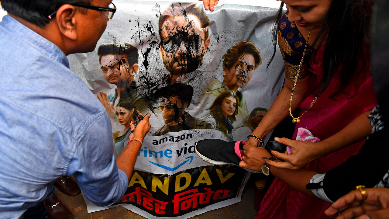 Supporters of India's ruling Bharatiya Janata Party (BJP) pour ink and beat a poster with footwear during a protest against a new web series 'Tandav', in Mumbai. Credit: AFP Photo
