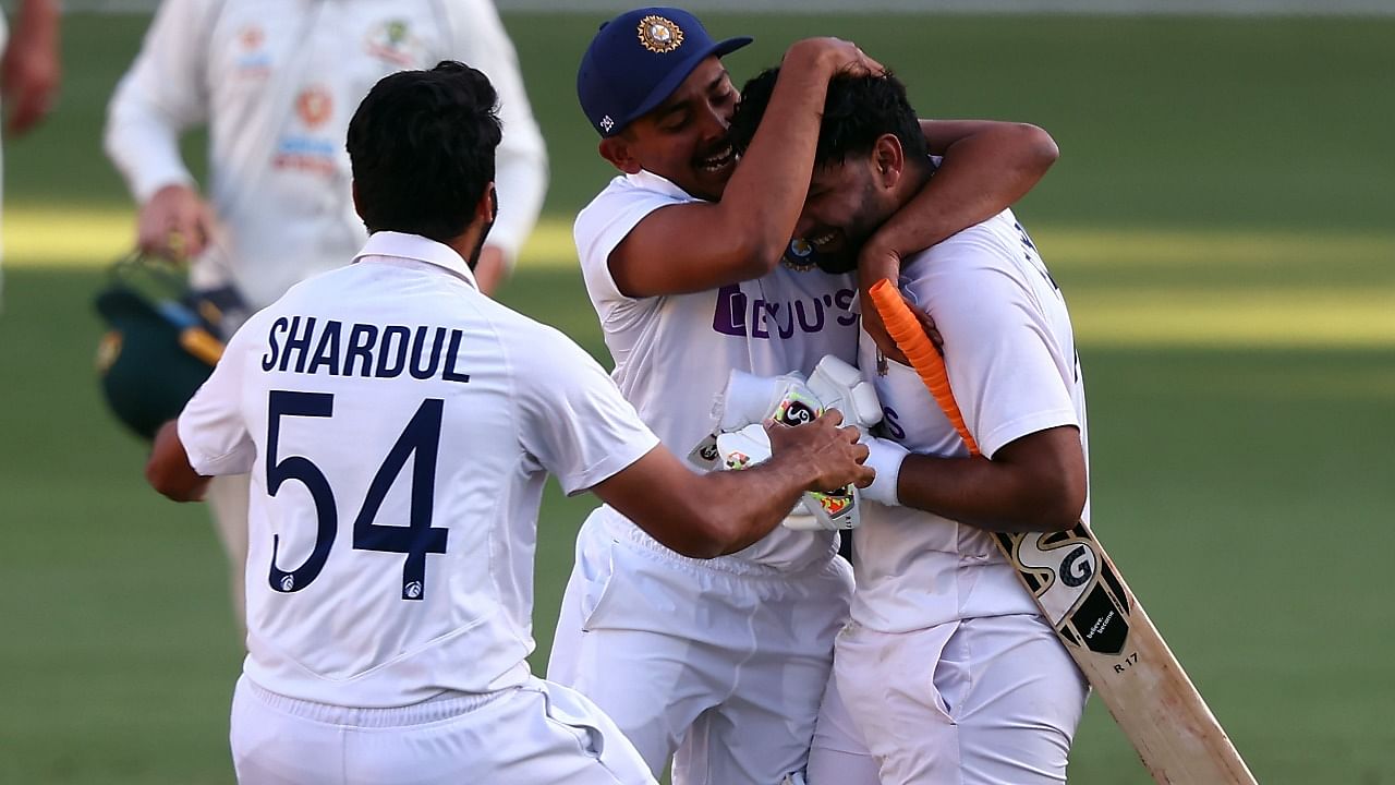 India's batsman Rishabh Pant (R) celebrates victory with teammates in the fourth cricket Test match against Australia at The Gabba in Brisbane on January 19, 2021. Credit: AFP Photo
