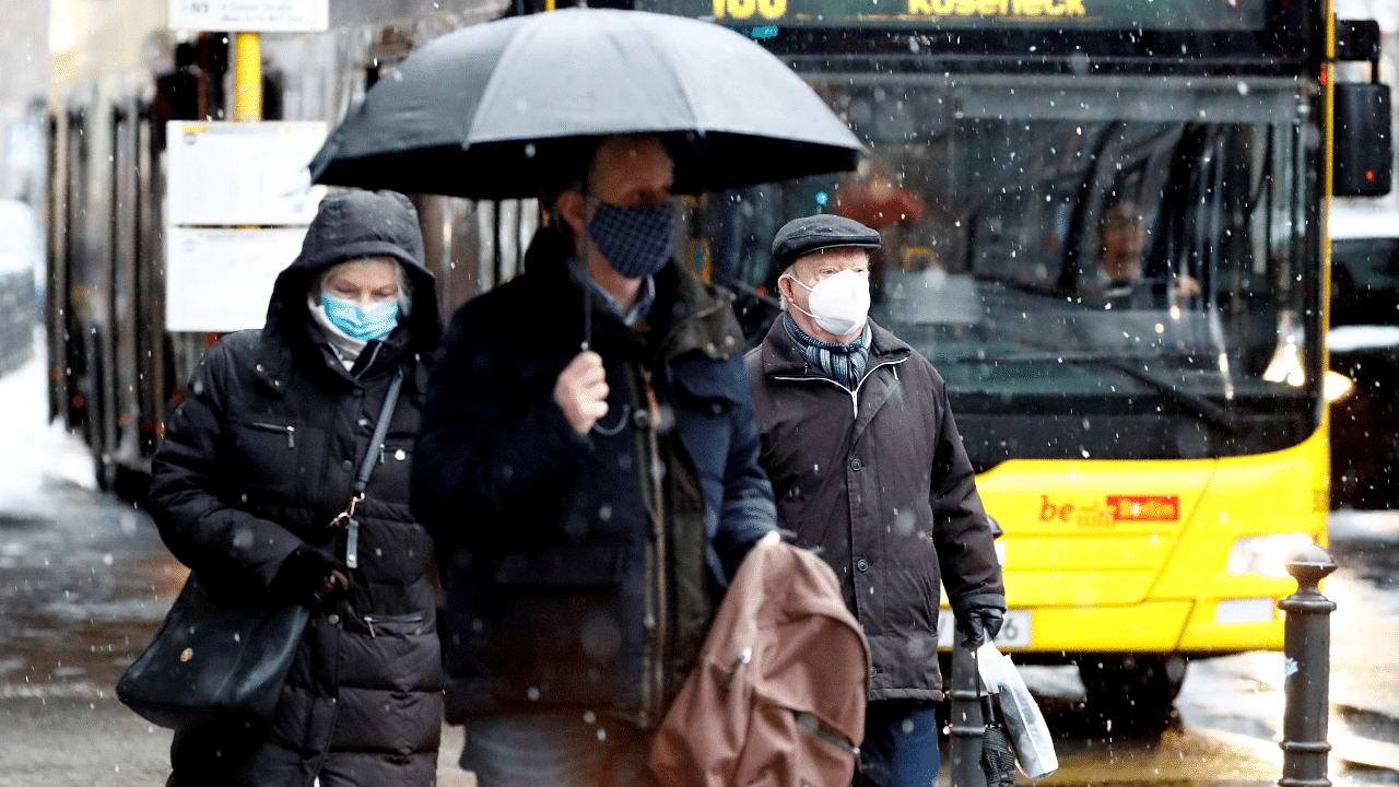 People wear face masks as they walk past a bus during lockdown due to the coronavirus disease pandemic in Berlin, Germany. Credit: Reuters Photo