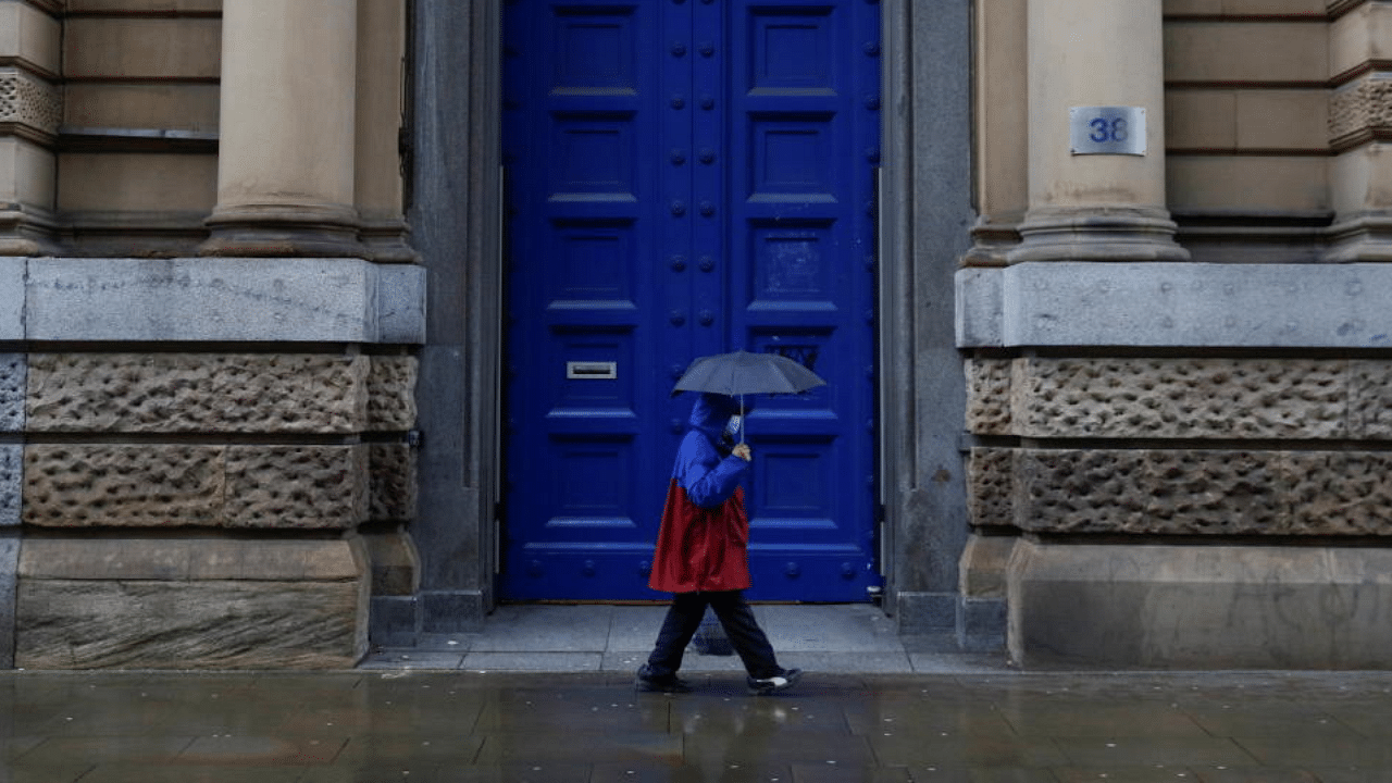 A woman walks past a former bank building, amidst the spread of the coronavirus disease (COVID-19), in Manchester, Britain, January 18, 2021. Credit: Reuters Photo