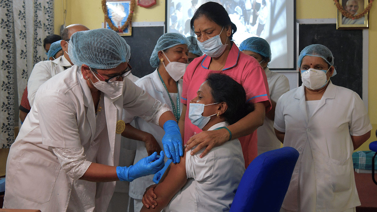 A medical worker inoculates a colleague with a Covid-19 coronavirus vaccine at the KC General hospital in Bangalore. Credit: AFP Photo