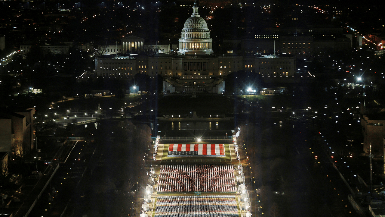 The "Field of Flags" is illuminated on the National Mall as the US Capitol Building is prepared for the inauguration of Joe Biden. Credit: Reuters Photo