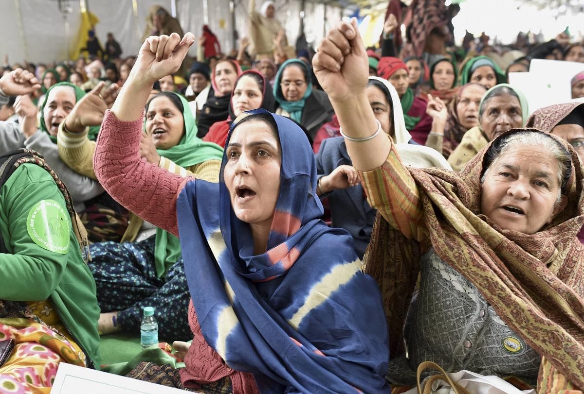 Women shout slogans during farmers' protest against new farm laws, at the Singhu Border in New Delhi, Monday, Jan. 18, 2021. Credit: PTI Photo