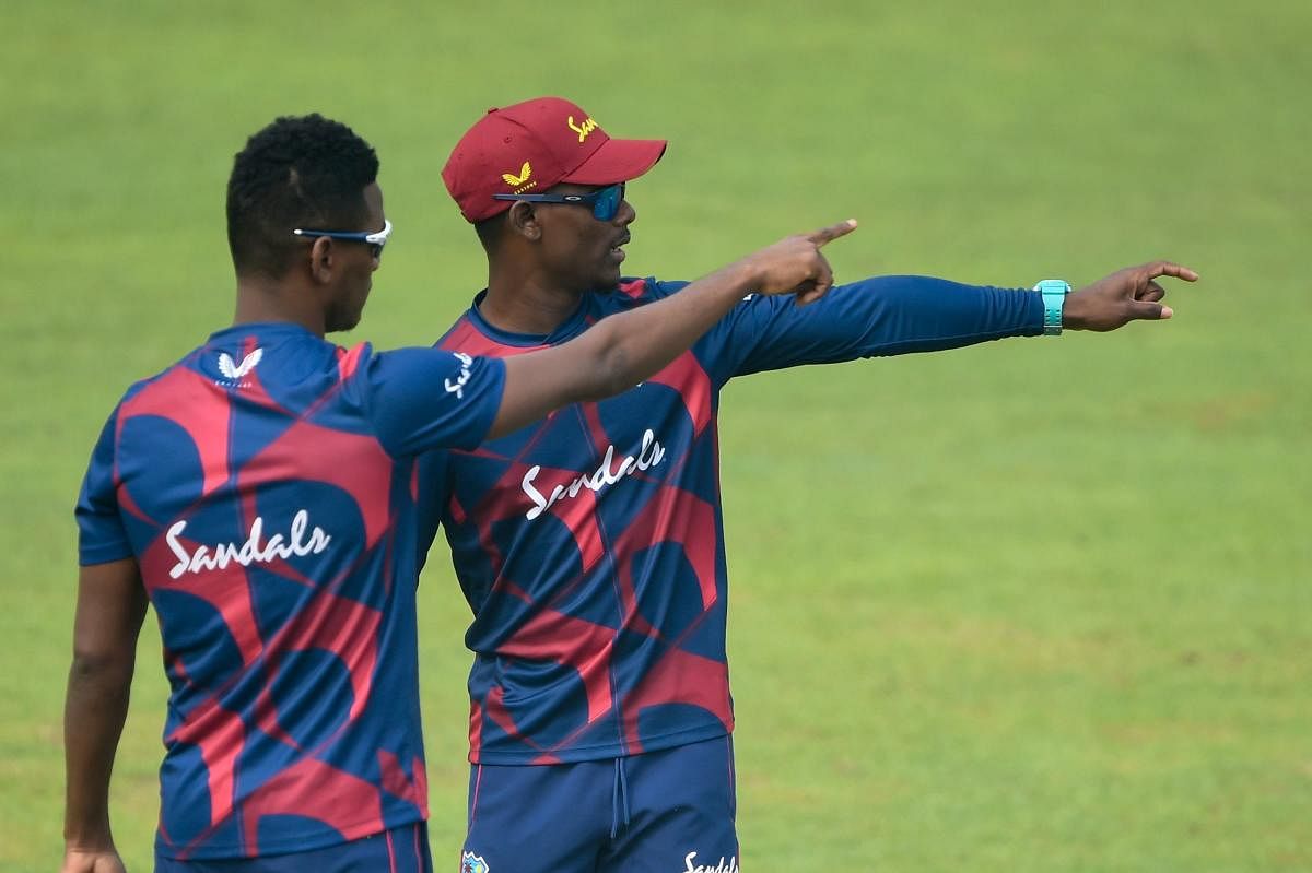West Indies' Jason Mohammed (R) talks to his teammate Akeal Hosein during a practice session at the Sher-e-Bangla National Cricket Stadium in Dhaka. Credit: AFP. 