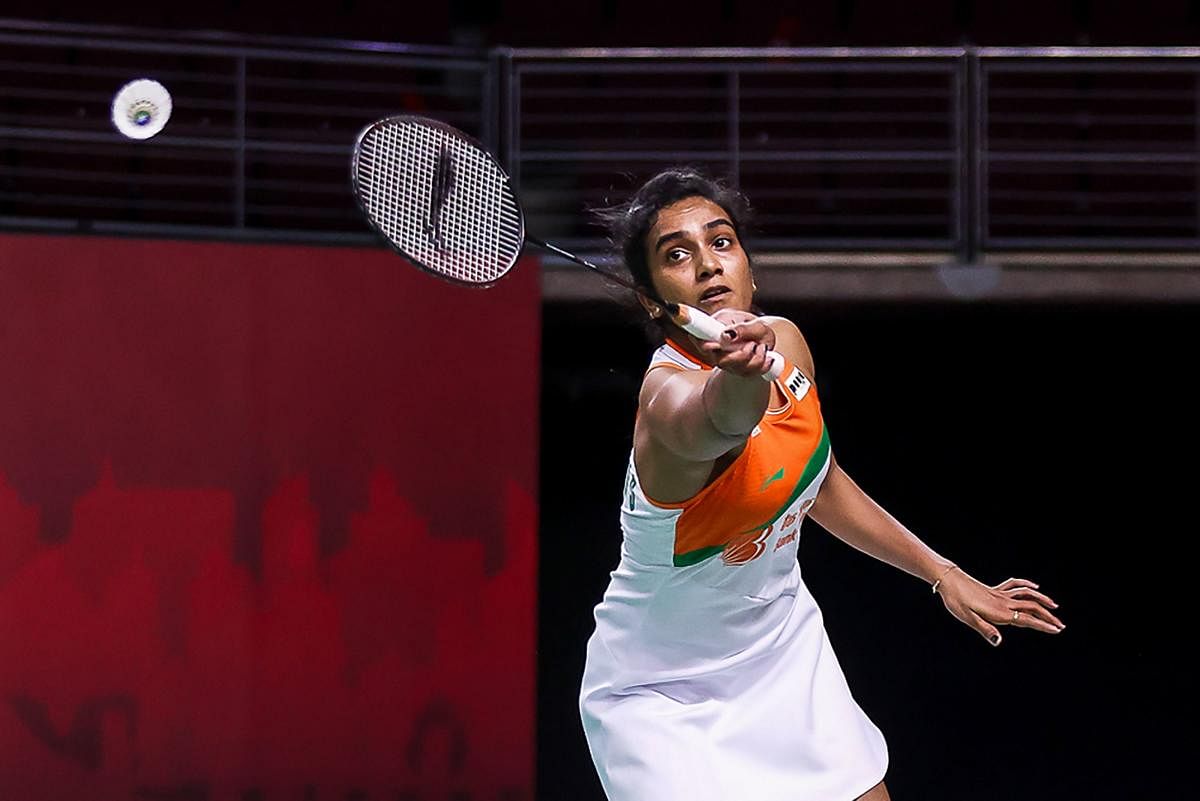 PV Sindhu in action against Thailand's Busanan Ongbamrungphan during their women's singles first round match at the Toyota Thailand Open badminton tournament in Bangkok. Credit: AFP. 