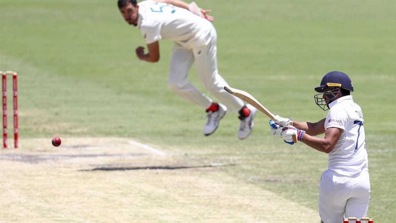 Shubman Gill hits a delivery from Australia's Mitchell Starc during play on the final day of the fourth cricket test between India and Australia at the Gabba. Credit: AP/PTI.