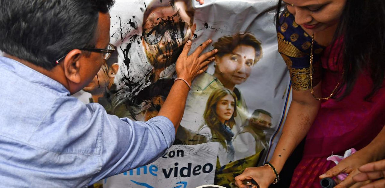 BJP supporters pour ink and beat a poster with footwear during a protest against a new web series 'Tandav', in Mumbai. Credit: AFP. 