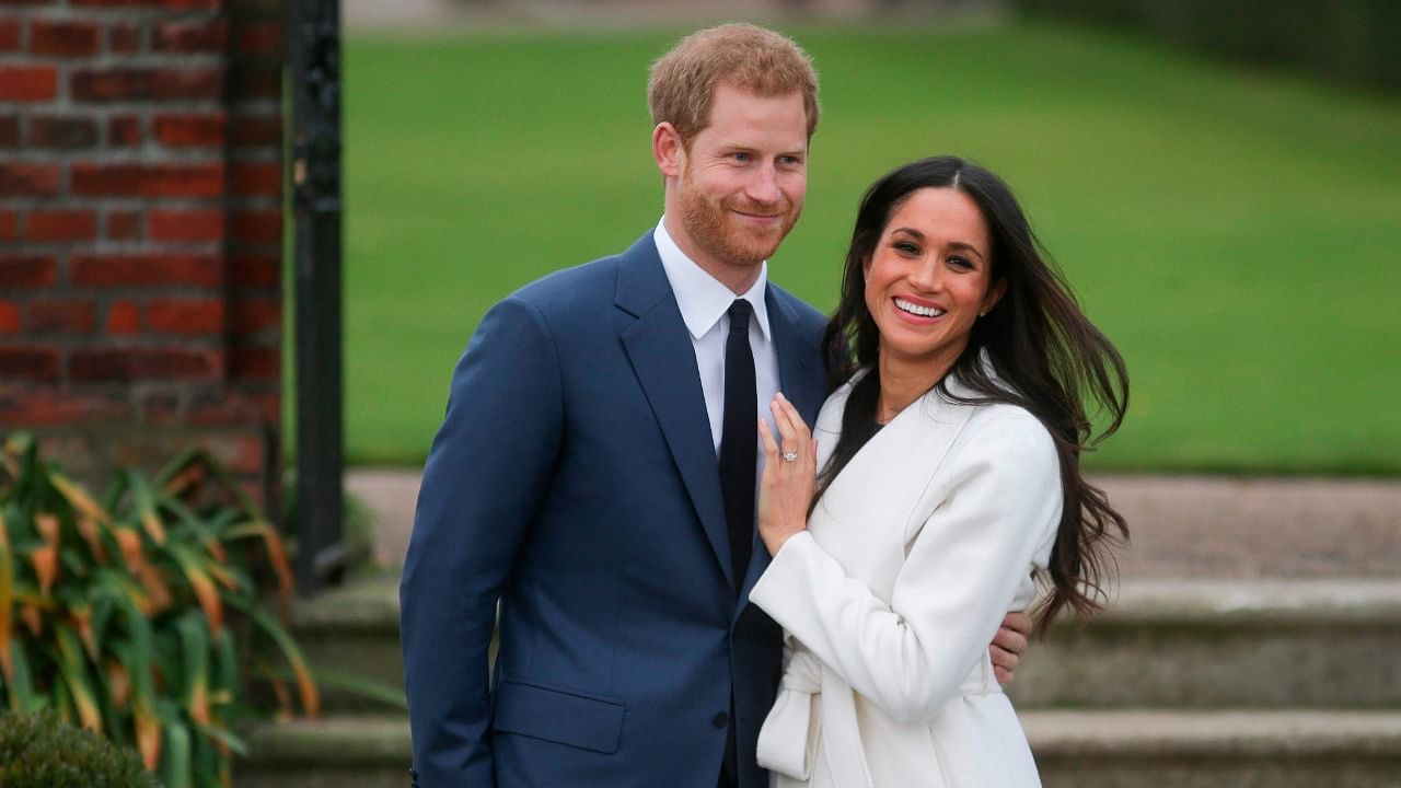 In this file photo taken on November 27, 2017 Britain's Prince Harry and his fiancée US actress Meghan Markle. Credit: AFP Photo