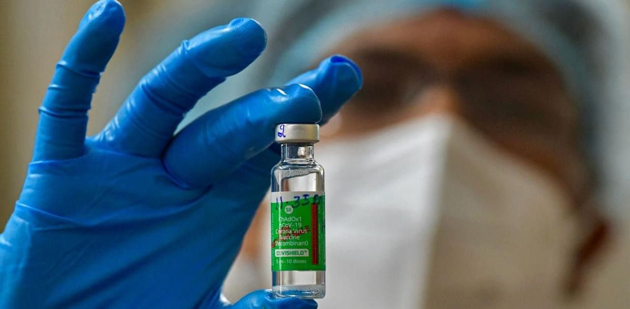 A nurse displays a vial of Covishield, AstraZeneca's Covid-19 coronavirus vaccine made by India's Serum Institute, as she prepares to inoculate her colleagues at the KC General hospital in Bangalore on January 16, 2021. Credit: AFP Photo