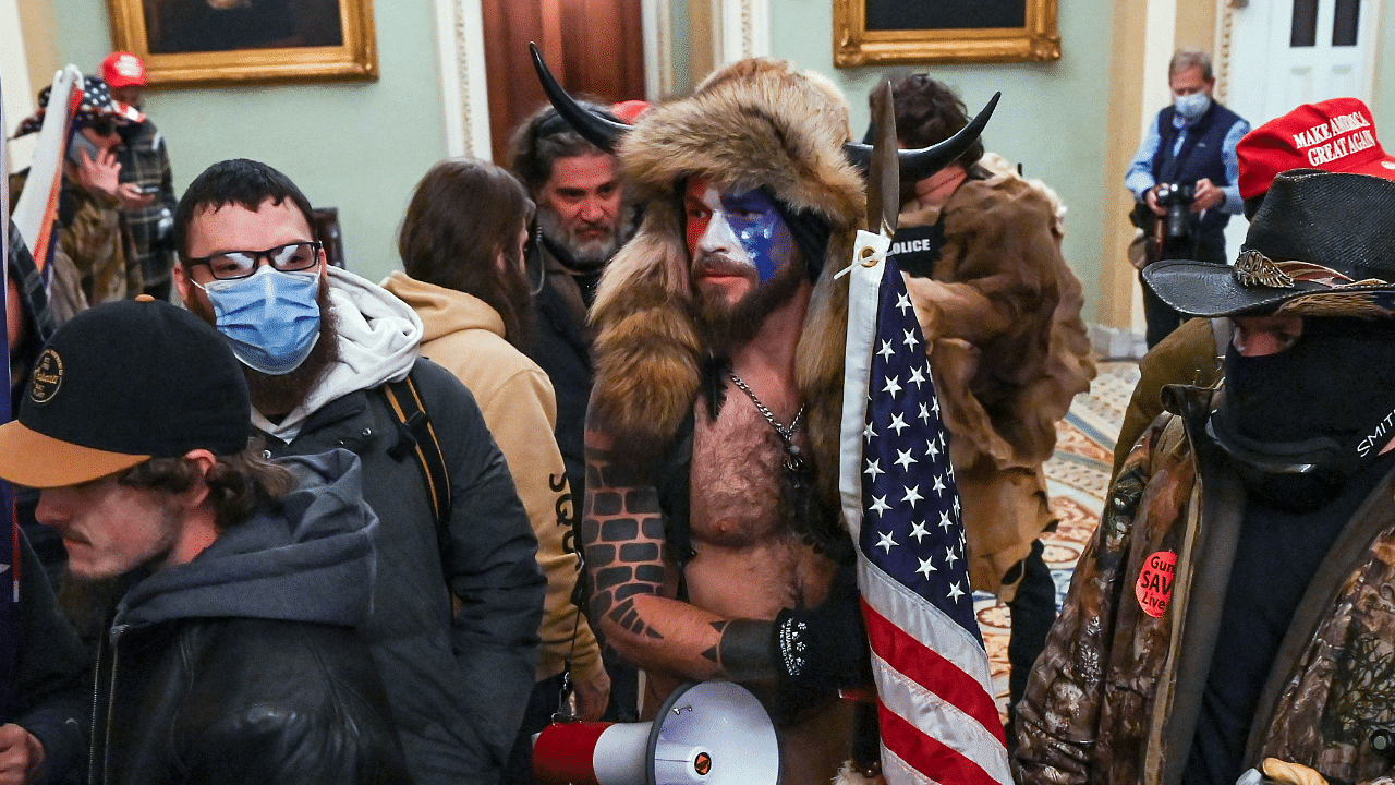 In this file photo taken on January 06, 2021, supporters of US President Donald Trump, including Jake Angeli (C), a QAnon supporter, enter the Capitol in Washington, DC. Credit: Reuters File Photo