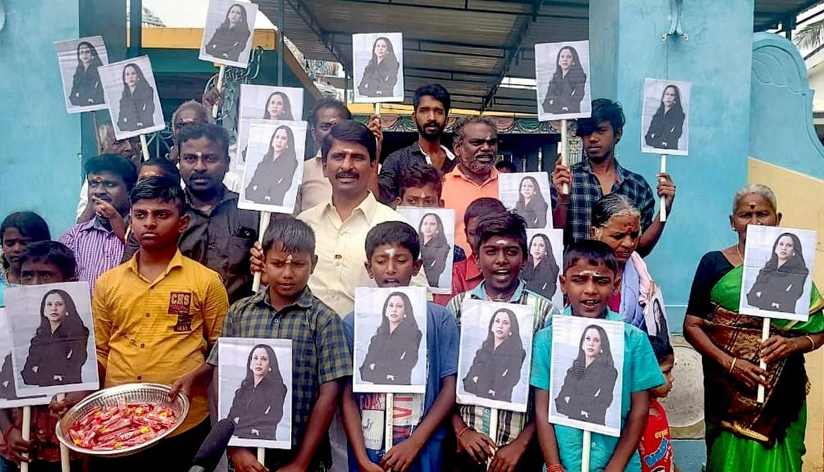 Villagers hold portraits of U.S. Vice President-elect Kamala Harris after participating in special prayers ahead of her oath taking ceremony, at Thulasendrapuram- hometown of Harris' maternal grandfather, in Tiruvarur district, Wednesday, Jan. 20, 2021. Credit: PTI Photo