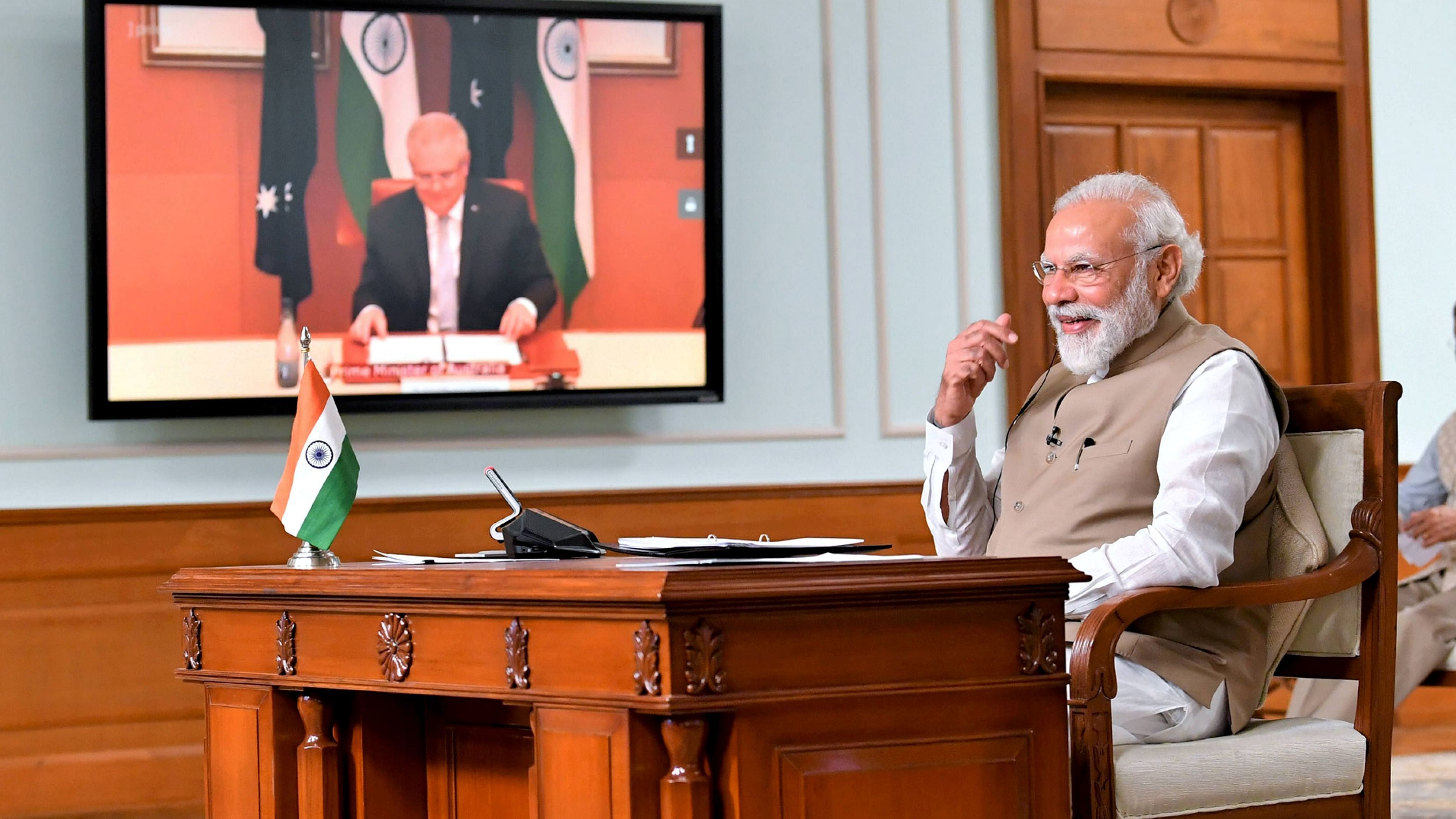 Prime Minister Narendra Modi during his first-ever virtual summit with his Australian counterpart Scott Morrison (on the screen), in New Delhi. Credit: PTI