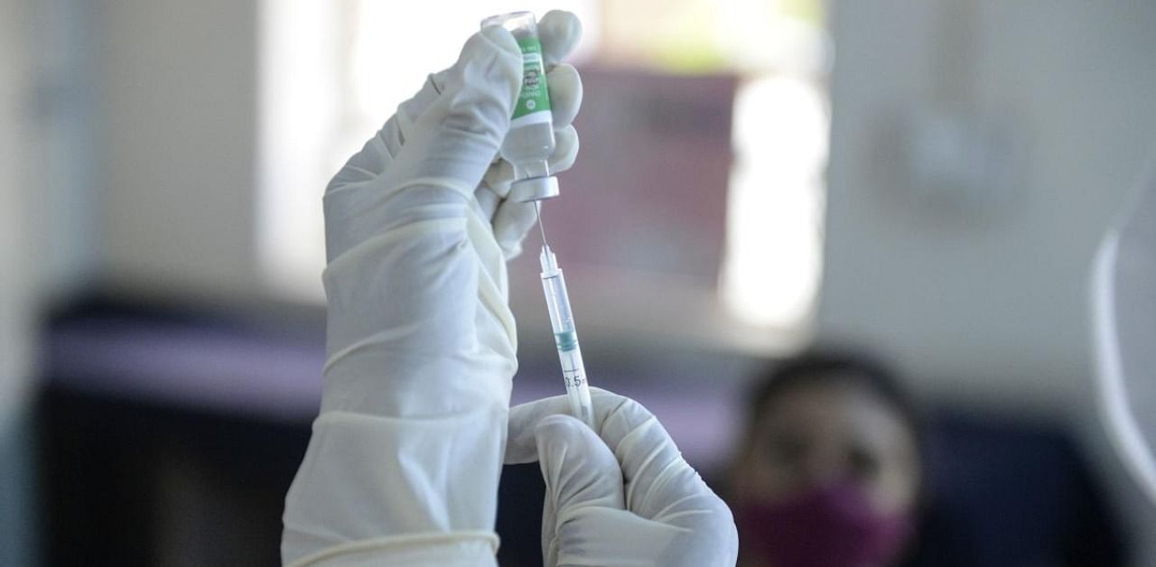 A health worker prepares to inoculate a colleague with a Covid-19 coronavirus vaccine at the Osmania Medical College, in Hyderabad on January 19, 2021. Credit: AFP Photo