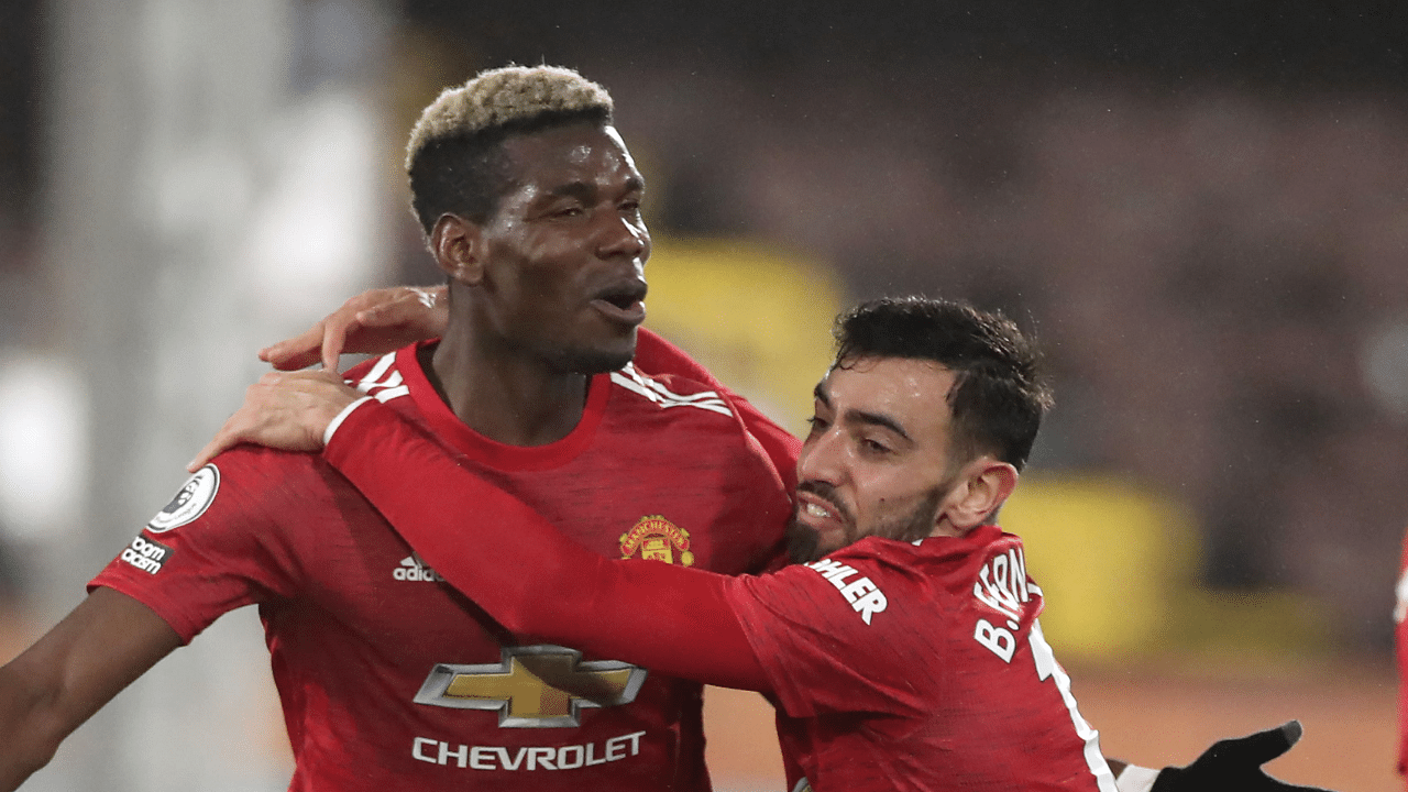 Paul Pogba  (L) celebrates scoring Manchester United's winning goal with Bruno Fernandes (R) in a 2-1 win over Fulham in the Premier League. Credit: Reuters Photo