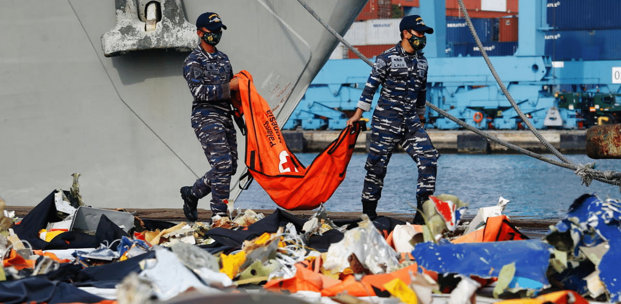 Indonesian navy personnel carry a body bag on the last day of search and rescue operation for Sriwijaya Air flight SJ 182, which crashed into the Java sea, at Tanjung Priok port in Jakarta. Credit: Reuters Photo