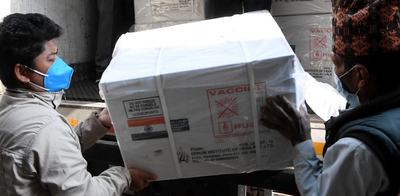 Workers unload a box containing Covid-19 coronavirus vaccine manufactured in India, at the Department of Health Services in Kathmandu. Credit: AFP Photo