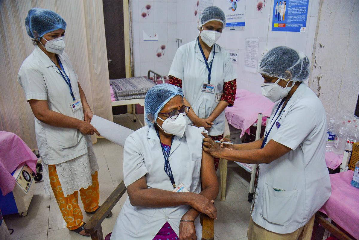 A medic vaccinates a health worker during a nationwide drive in Thane on Wednesday. Credit: PTI