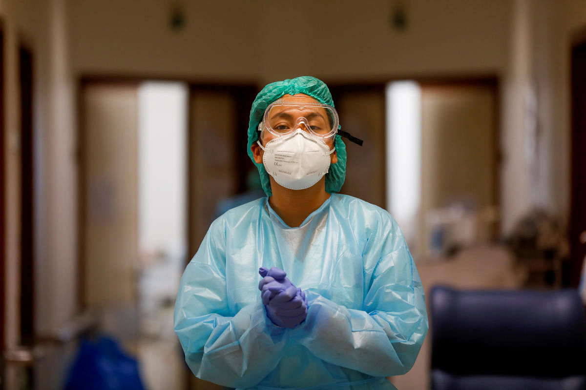 A health care worker wears personal protective equipment in Santa Maria Hospital Intermediate care unit, during the coronavirus disease (Covid-19) pandemic in Lisbon, Portugal. Credit: Reuters. 