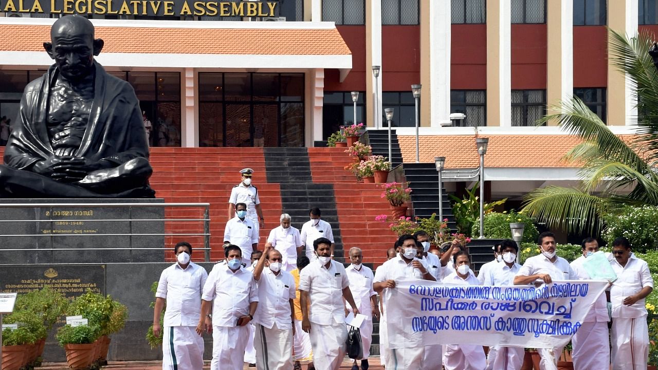 Opposition MLAs stage a protest outside Kerala Legislative complex, demanding the resignation of Speaker P. Sreeramakrishnan over his alleged involvement in gold smuggling case, after boycotting the assembly session, in Thiruvananthapuram on January 08, 2021. Credit: PTI Photo