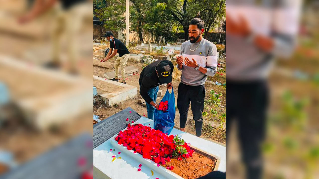  Indian Pacer Mohammed Siraj pays respect to his father Mohammed Ghouse after his arrival in the city, at a graveyard in Hyderabad. Credit: PTI Photo