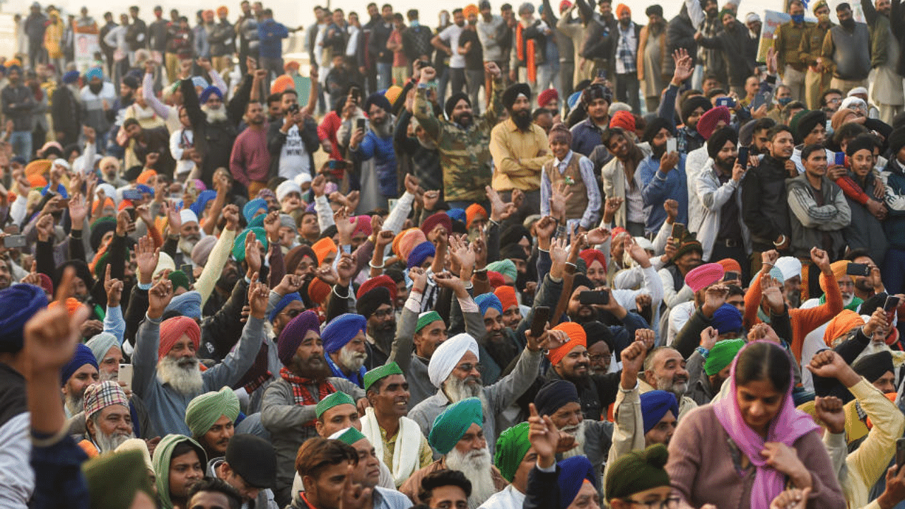 Farmers raise slogans during a protest against the new farm laws at Delhi-UP Ghazipur border, in New Delhi, Tuesday, Jan. 19, 2021. Credit: PTI Photo