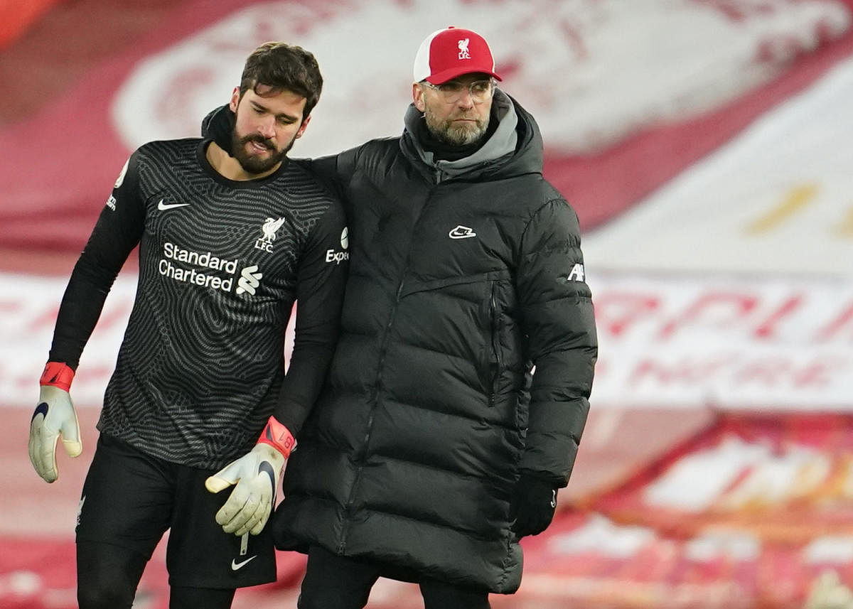 Liverpool's Alisson looks dejected with manager Juergen Klopp. Credit: Reuters. 