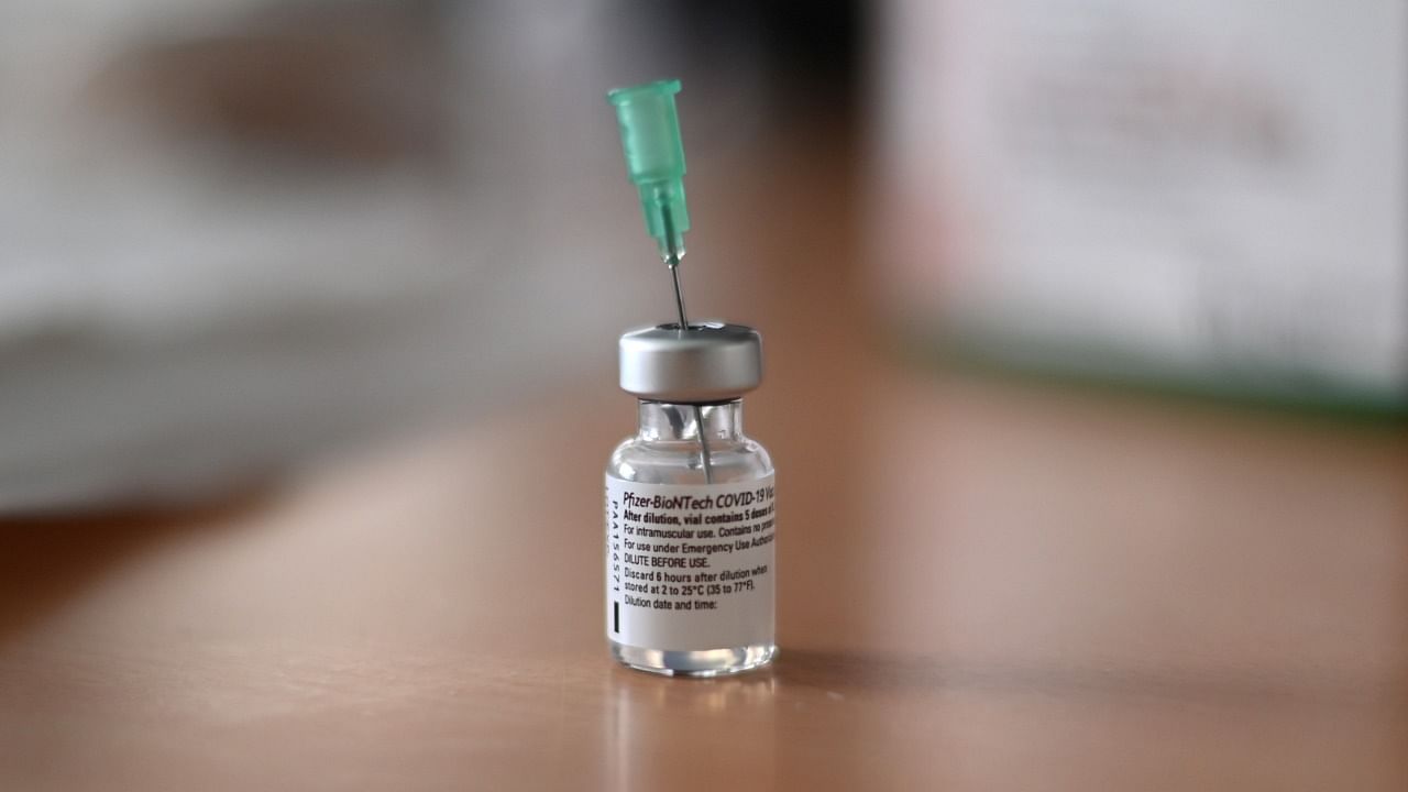 An injection needle sits in a vial with the Pfizer-BioNTech Covid-19 vaccine. Credit: AFP Photo