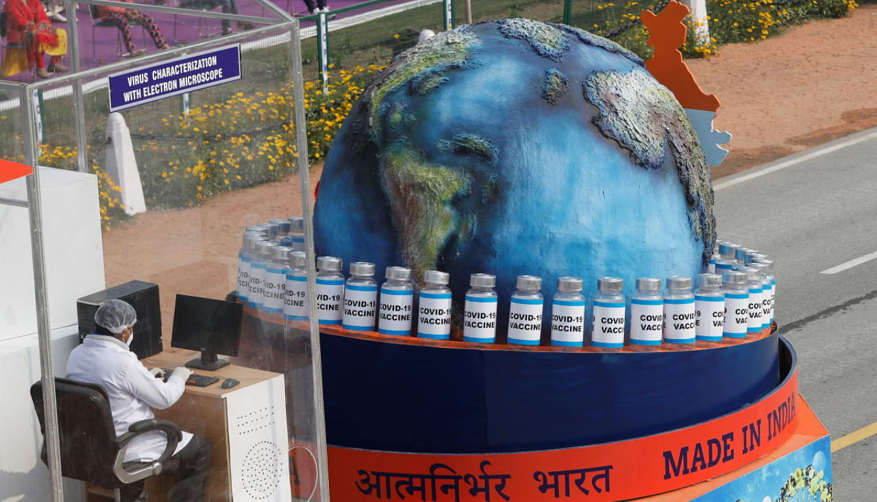 A tableau depicting the globe and vials reading 'COVID-19 VACCINE' is displayed during the full dress rehearsal for the Republic Day parade in New Delhi, India, January 23, 2021. Credit: REUTERS