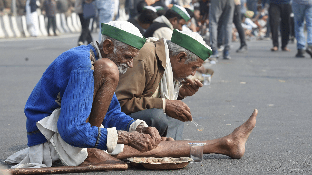  Farmers have 'langar' during ther protest at Delhi-UP border over Centre's farm reform laws, in New Delhi. Credit: PTI Photo