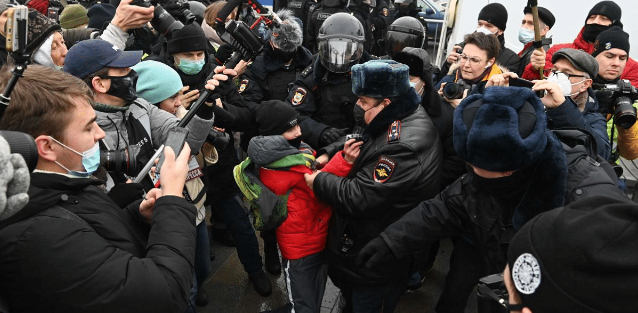 Police detain a boy during a rally in support of jailed opposition leader Alexei Navalny in downtown Moscow. Credit: AFP Photo