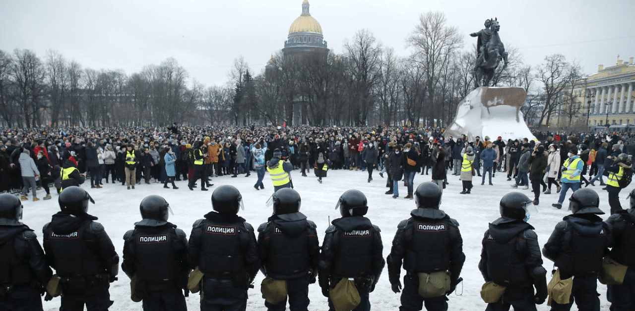 Police stand guard during a protest against the jailing of opposition leader Alexei Navalny in St. Petersburg, Russia. Credit: AP Photo