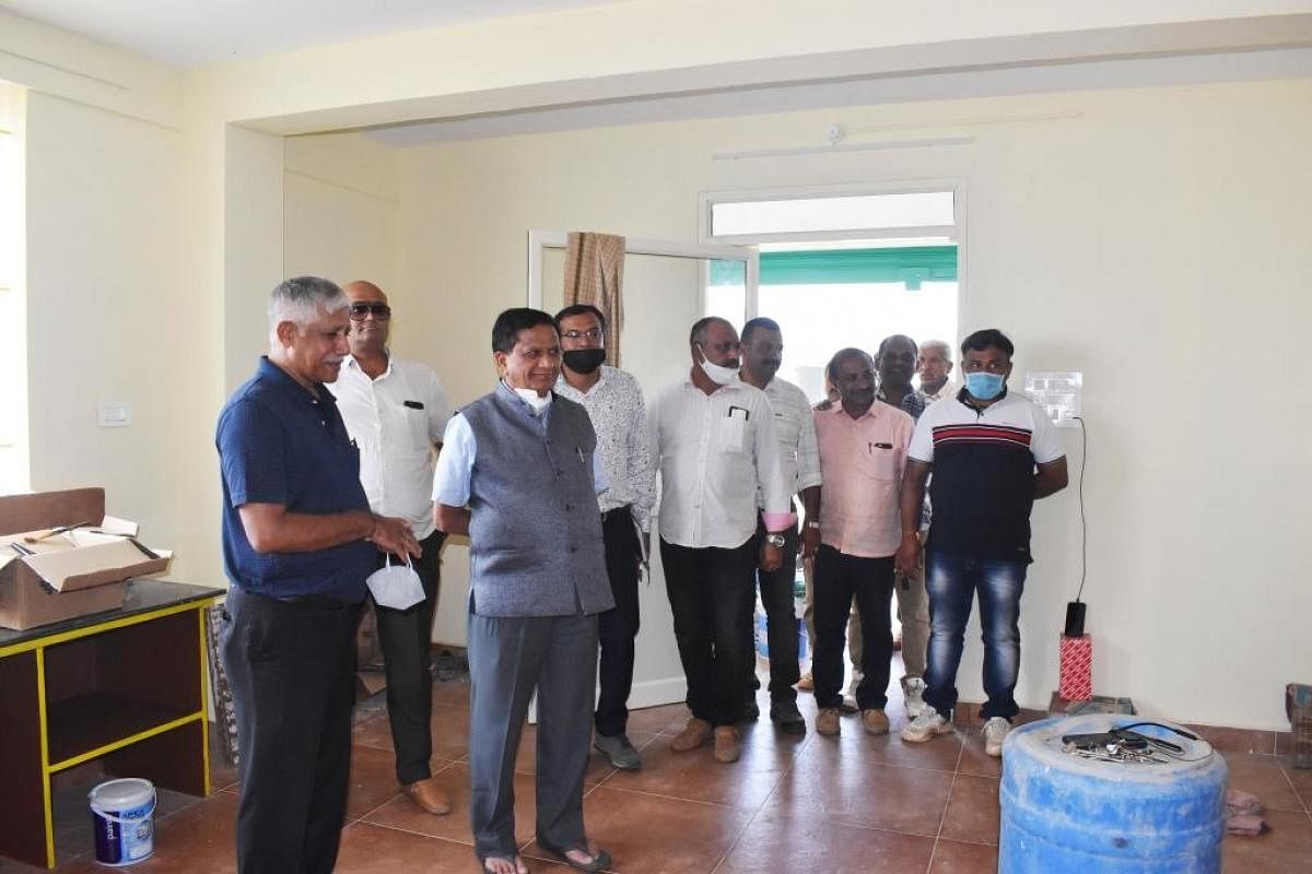 MLA K G Bopaiah inspects the new HOPCOMS building in Madikeri.