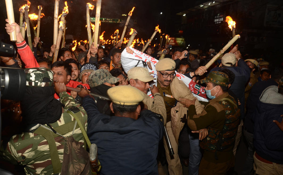 Security personnel stop activists of All Assam Students Union (AASU) who were staging a torch rally to protest against Citizenship Amendment Act 2019, in Dibrugarh, Assam, Friday, Jan. 22, 2021. Credit: PTI Photo