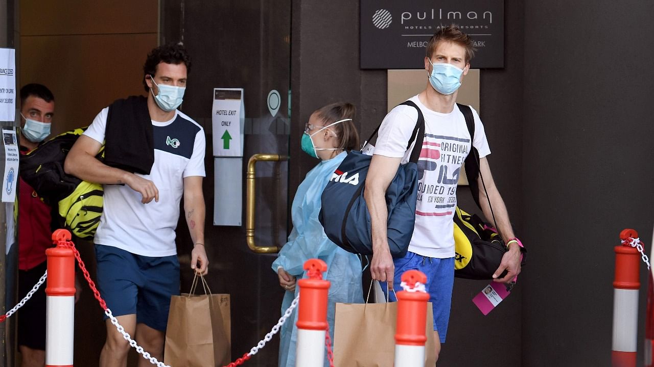 Tennis players leave a hotel for a practice session in Melbourne on January 22, 2021, as some players are allowed to train while serving quarantine for two weeks ahead of the Australian Open tennis tournament. Credit: AFP Photo