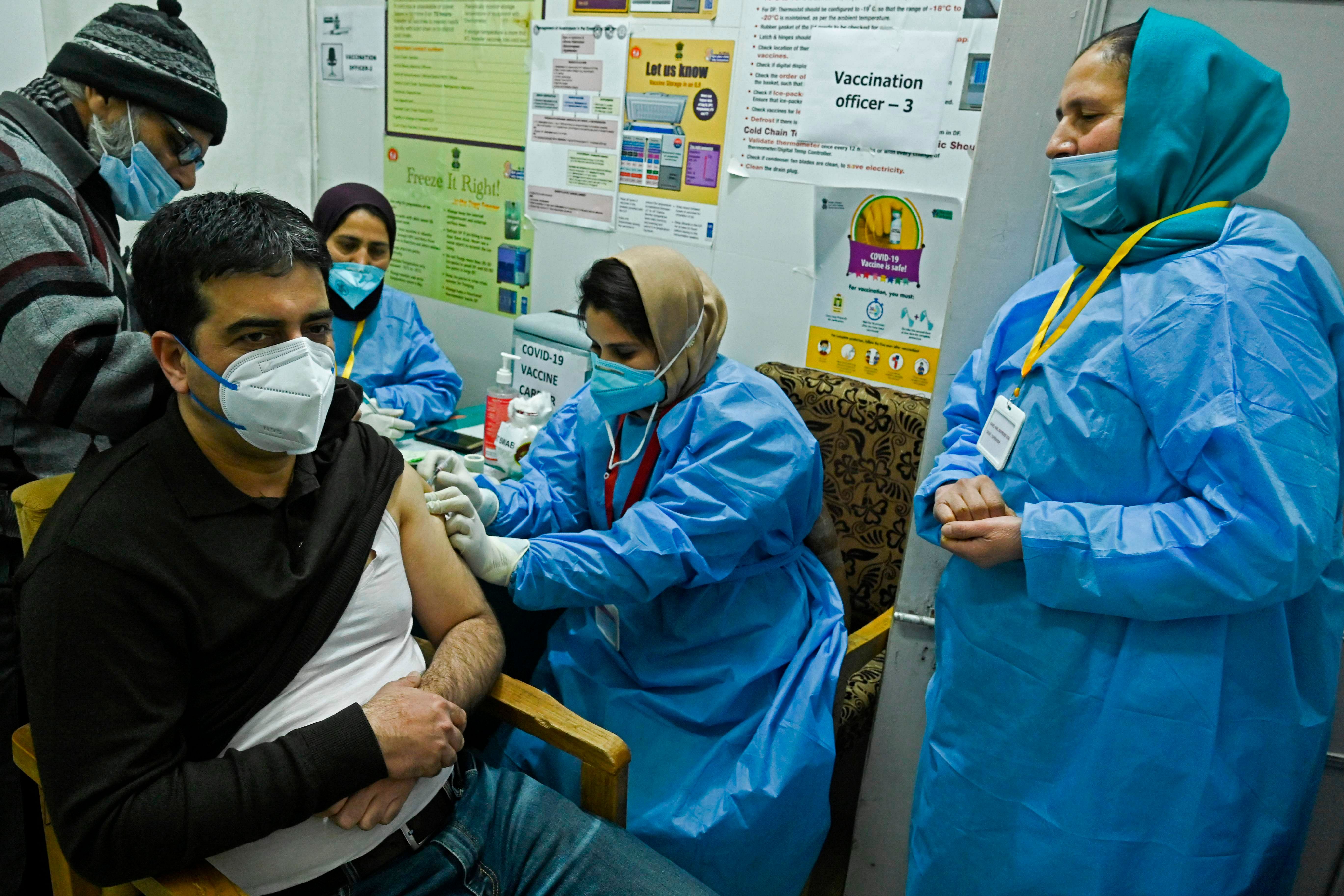 A medical worker inoculates a staff member with Covid-19 coronavirus vaccine at the G.B. Pant hospital in Srinagar on January 22, 2021. Credit: AFP Photo